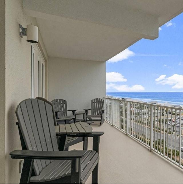 balcony with a view of the beach and a water view