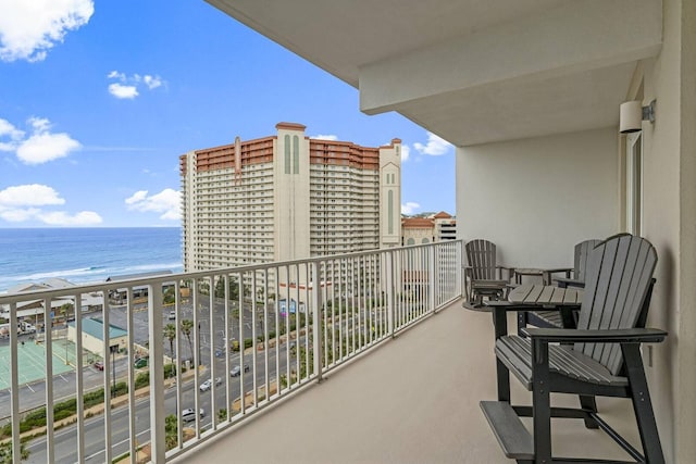 balcony featuring a beach view and a water view