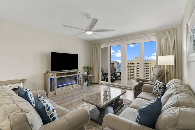 living room with ceiling fan and wood-type flooring