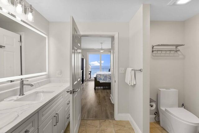 bathroom with toilet, ceiling fan, tile patterned floors, and vanity