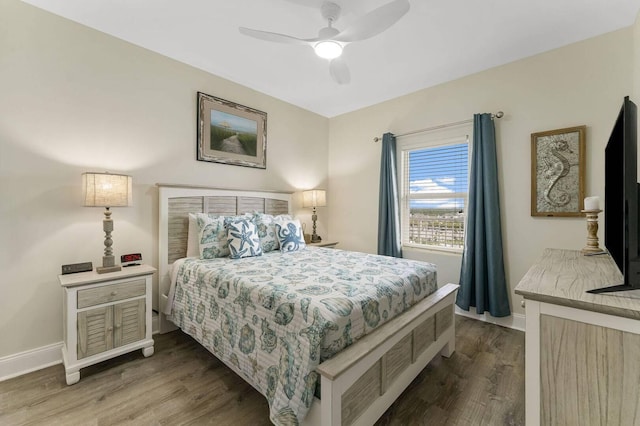 bedroom with ceiling fan and hardwood / wood-style flooring