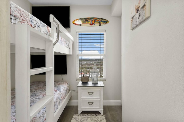 bedroom with dark hardwood / wood-style flooring