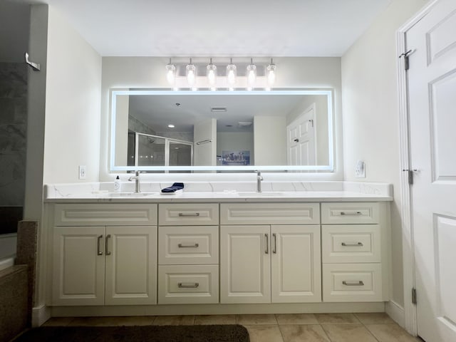 bathroom with walk in shower, tile patterned flooring, and vanity