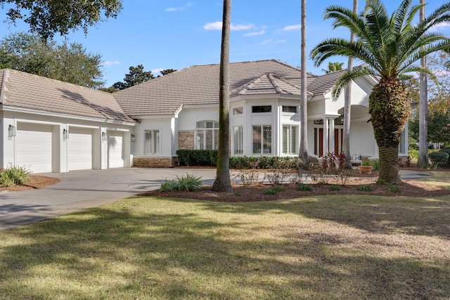 view of front of home with a front yard and a garage