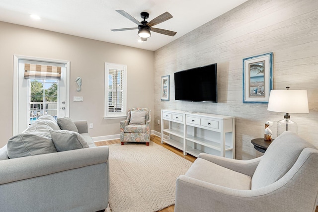 living room featuring ceiling fan and hardwood / wood-style flooring