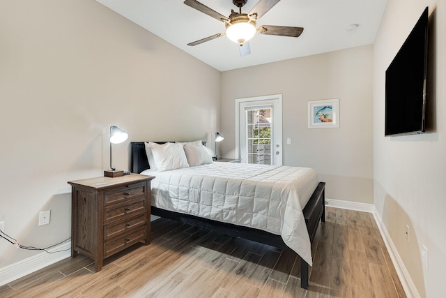 bedroom with ceiling fan, access to exterior, and light hardwood / wood-style floors