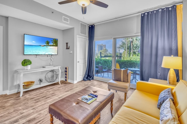 living room featuring ceiling fan and hardwood / wood-style flooring