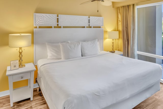 bedroom with ceiling fan and hardwood / wood-style floors