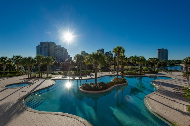 view of swimming pool with a patio area and a hot tub