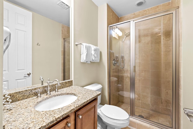 bathroom with toilet, walk in shower, and vanity