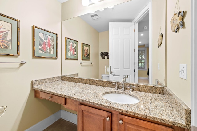 bathroom with toilet and vanity