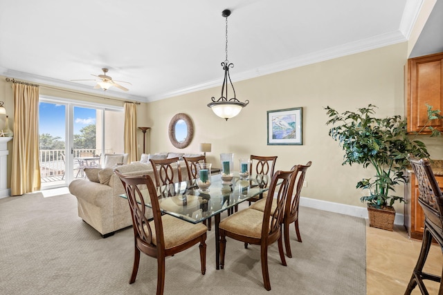 dining room featuring ceiling fan, light colored carpet, and crown molding