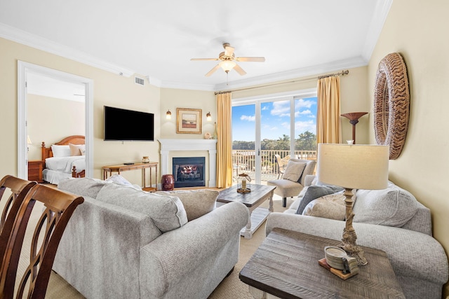 living room featuring ceiling fan and ornamental molding