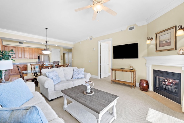 living room with light carpet, ceiling fan, and crown molding