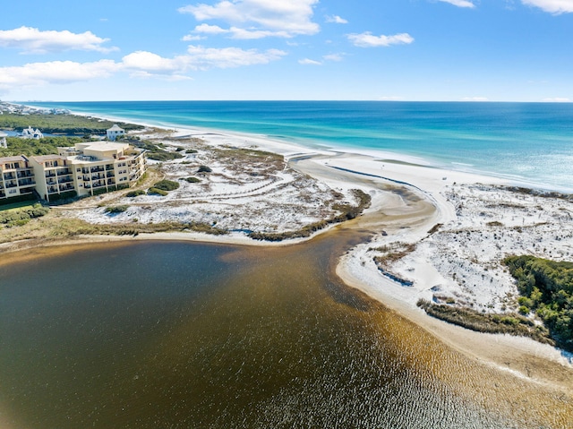 bird's eye view with a water view and a beach view