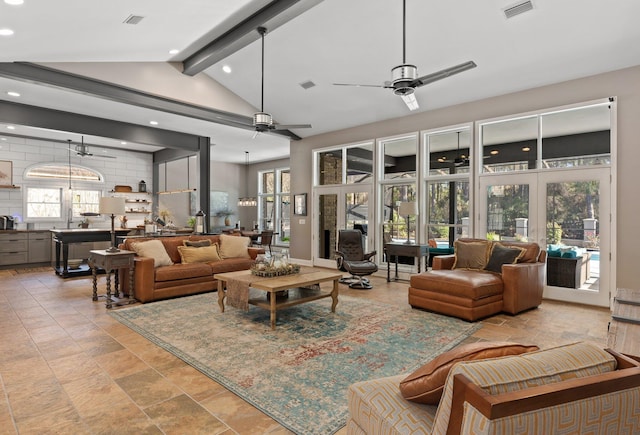 living room with vaulted ceiling with beams, ceiling fan, and french doors