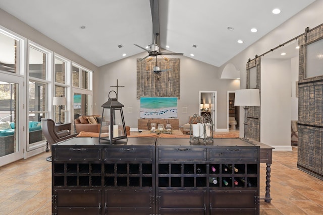 kitchen with a barn door, high vaulted ceiling, and ceiling fan