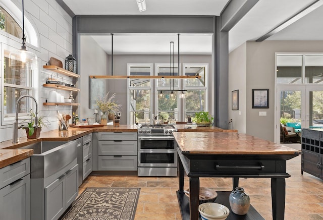 kitchen featuring sink, gray cabinetry, double oven range, backsplash, and french doors