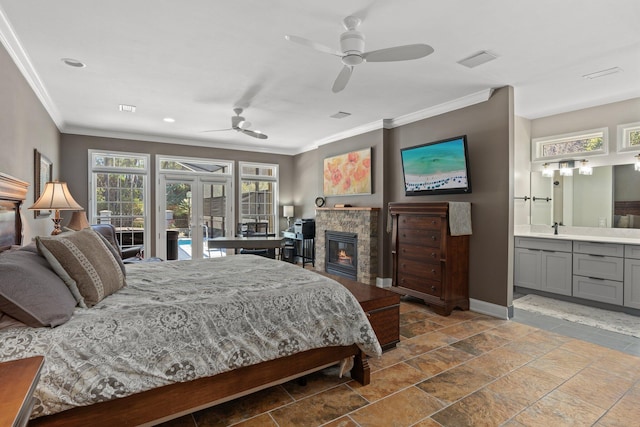 bedroom with connected bathroom, a stone fireplace, ornamental molding, ceiling fan, and access to exterior