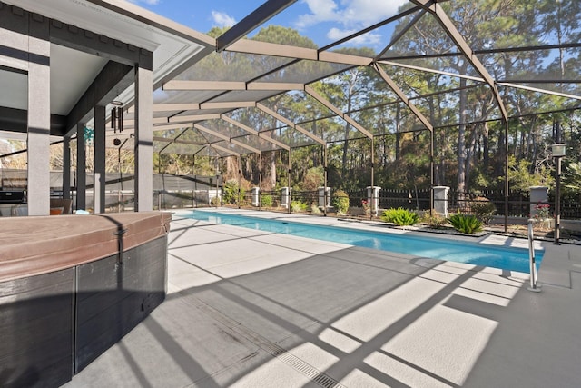 view of swimming pool with a patio, a hot tub, and glass enclosure