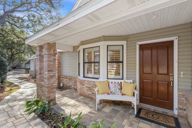 view of exterior entry with a porch