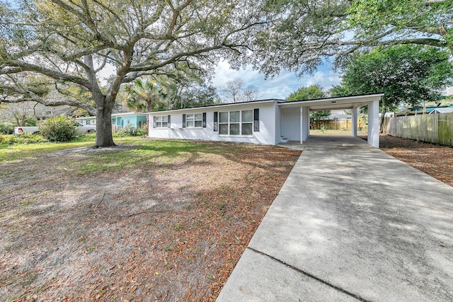 ranch-style home featuring a carport