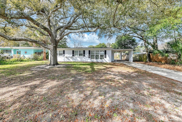 ranch-style home featuring a carport