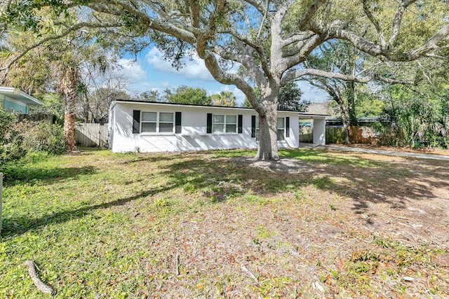 ranch-style home with a front lawn