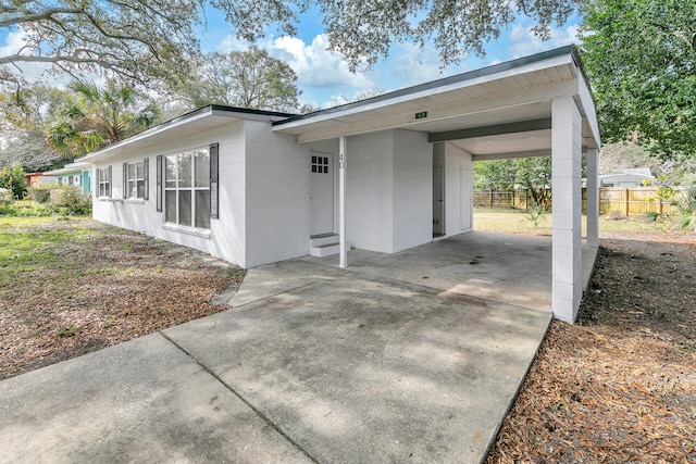 view of property exterior with a carport