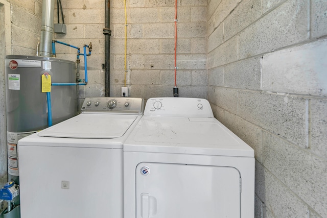 laundry room with washing machine and dryer and water heater