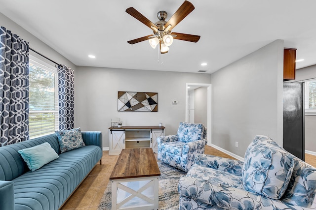 living room with ceiling fan and light tile patterned flooring