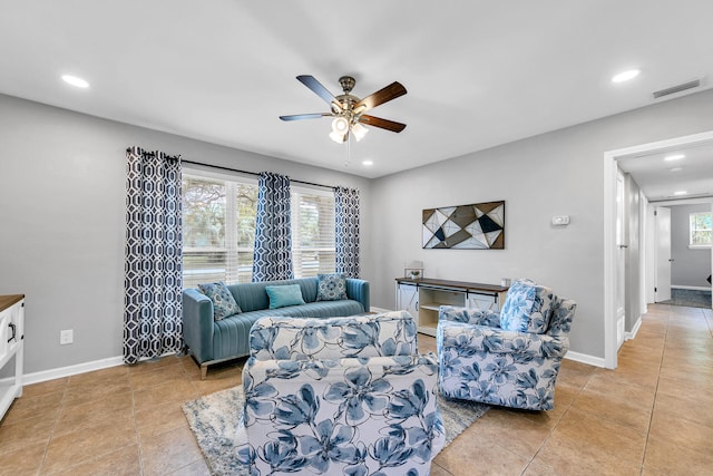 tiled living room featuring ceiling fan