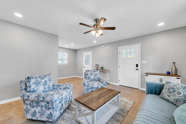 living room featuring ceiling fan and light tile patterned flooring