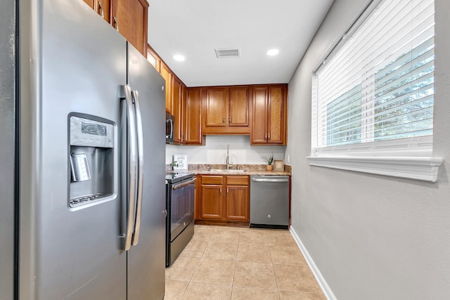 kitchen featuring light tile patterned floors, appliances with stainless steel finishes, and sink