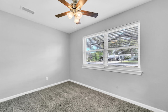 carpeted spare room featuring ceiling fan and a healthy amount of sunlight