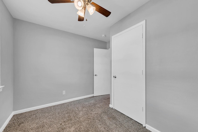 unfurnished bedroom featuring ceiling fan and carpet