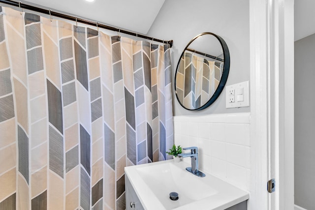 bathroom with tile walls, vanity, and a shower with curtain