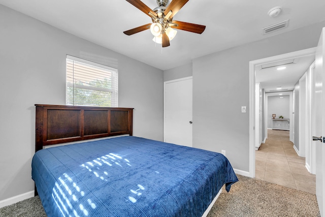 bedroom with light carpet and ceiling fan