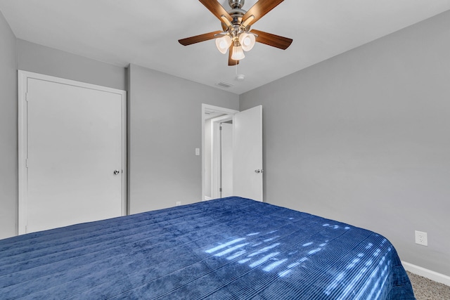 unfurnished bedroom featuring ceiling fan and carpet