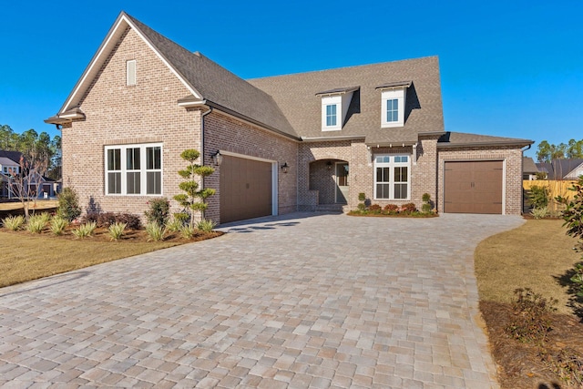 view of front of property with a garage and a front lawn