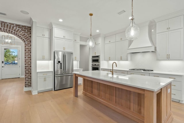 kitchen featuring sink, white cabinets, stainless steel appliances, and custom exhaust hood