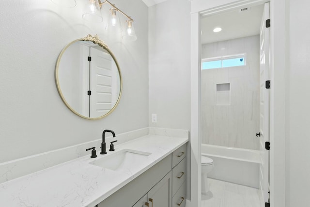 full bathroom featuring toilet, vanity, and tiled shower / bath combo