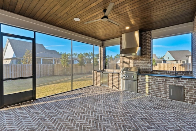 unfurnished sunroom with wood ceiling and sink