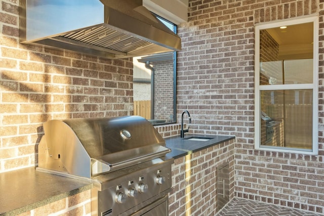 view of patio / terrace featuring exterior kitchen, sink, and grilling area