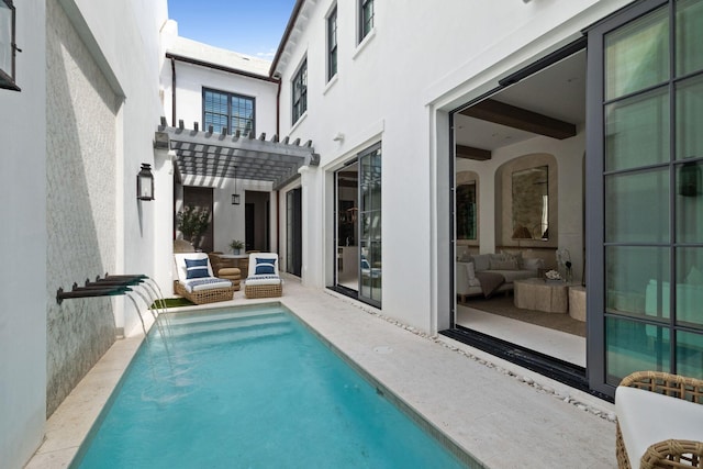 view of pool with pool water feature, a pergola, and outdoor lounge area