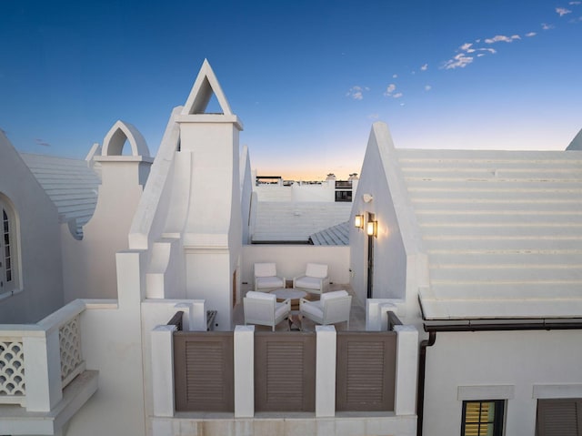 view of patio terrace at dusk