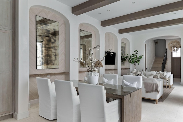 dining area featuring beamed ceiling