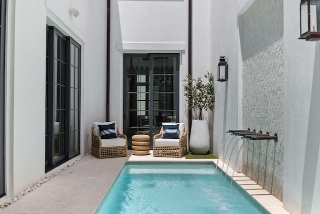 view of pool featuring french doors