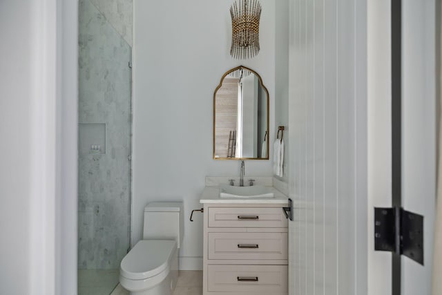 bathroom featuring toilet, vanity, and tile patterned flooring