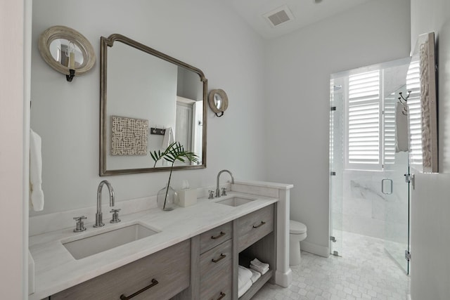 bathroom with toilet, walk in shower, and vanity